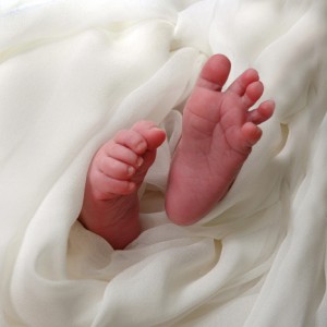 Photograph of anonymous baby feet swathed in white fabric
