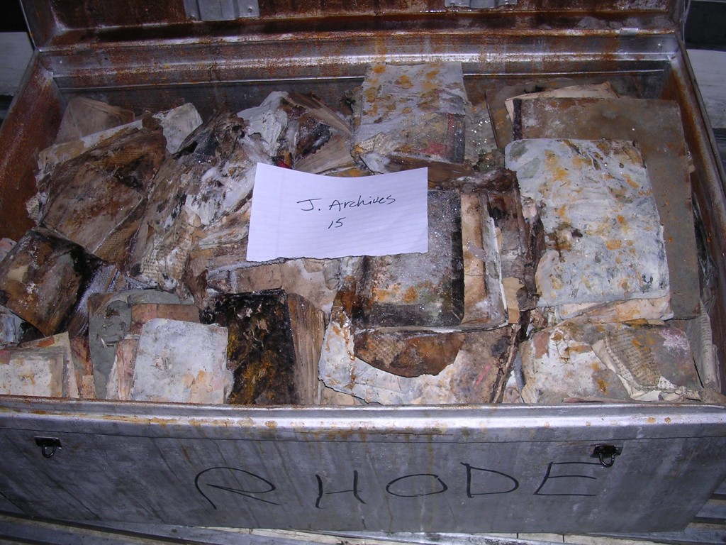 A labeled crate filled with books and documents