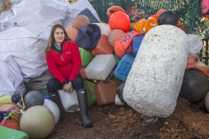 Portrait of the speaker surrounded by plastic containers