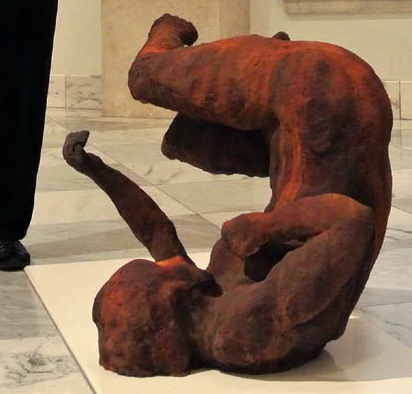 Bronze sculpture of woman in unnatural falling position