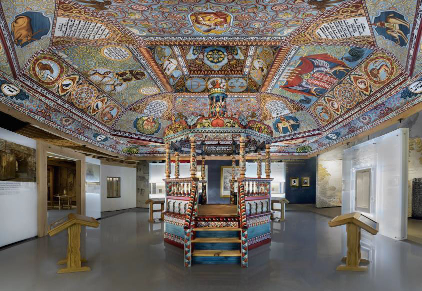 Highly decorated Painted ceiling and gazebo-like structure in a large gallery space.