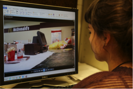A person works on a computer viewing a time-based media artwork