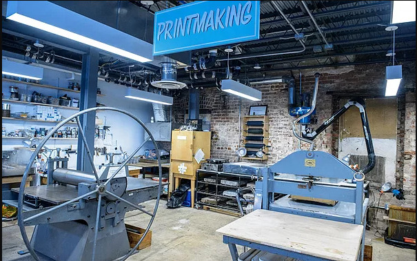 Large workspace with print-making rollers and presses.