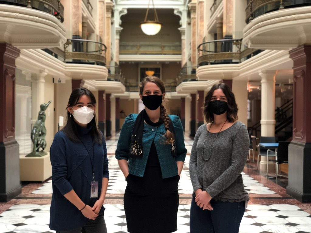 Three conservators in masks in the lobby of the Lunder Conservation Center