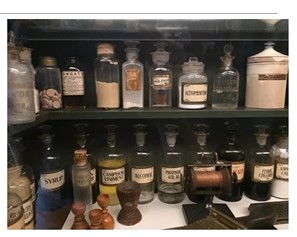 An orderly shelf of different sized bottles and canisters partially filled with powders and liquids