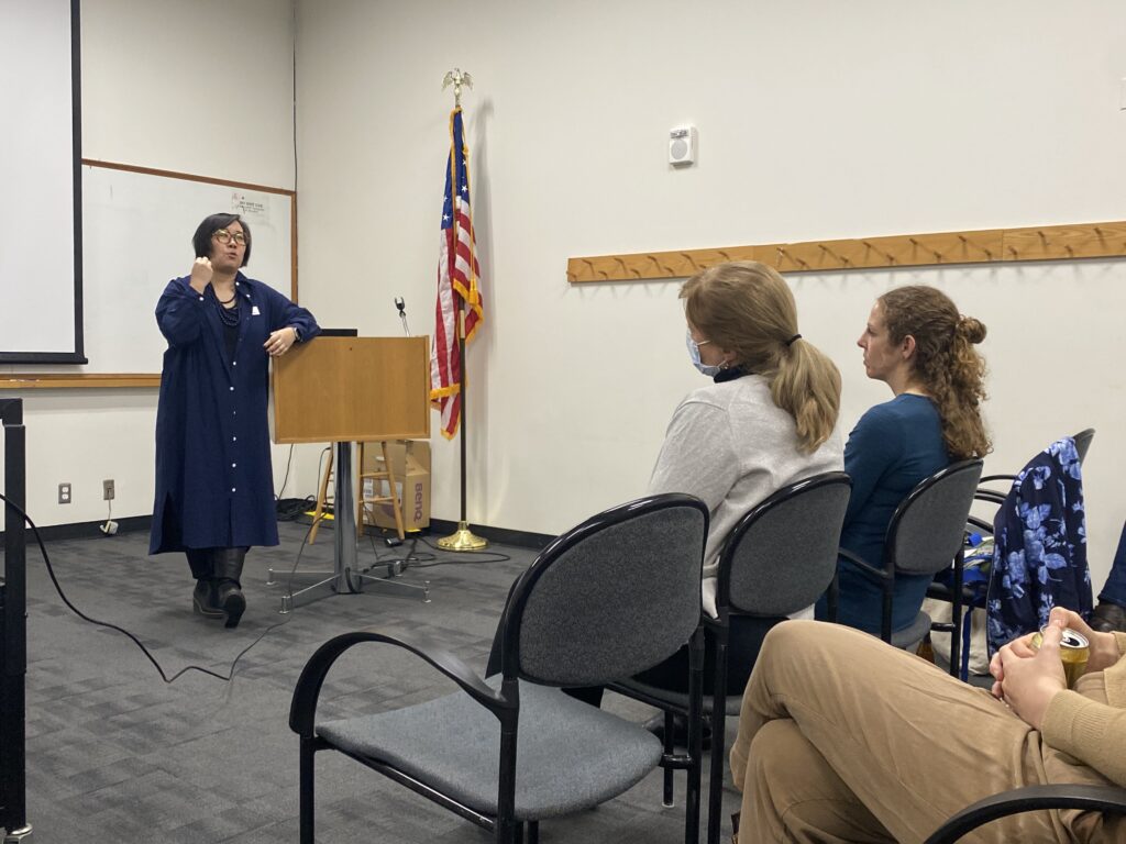 Lisa Sasaki stands at the font of a classroom delivering "Food For Thought: Building a New Smithsonian Museum" at the December Meeting of the Washington Conservation Guild