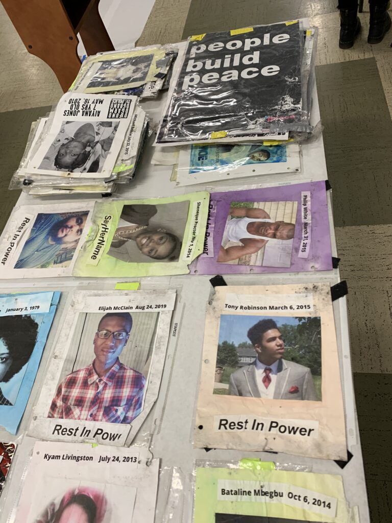 Memorial posters ready to be housed, spread out over a table surface