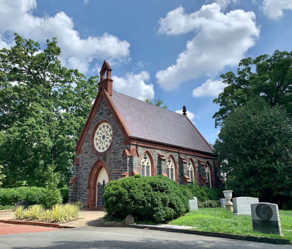 Image of a stone church with multiple grave markers