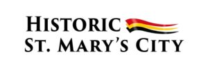 Logo with black text on a white background reading "Historic St. Mary's City" with an abstraction of a flag graphic with red-yellow-and-black vertical stripes, as in the State of Maryland's flag.