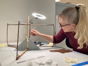 Conservator performing triage treatment on collection material from the The National Air and Space Museum of the Smithsonian Institution